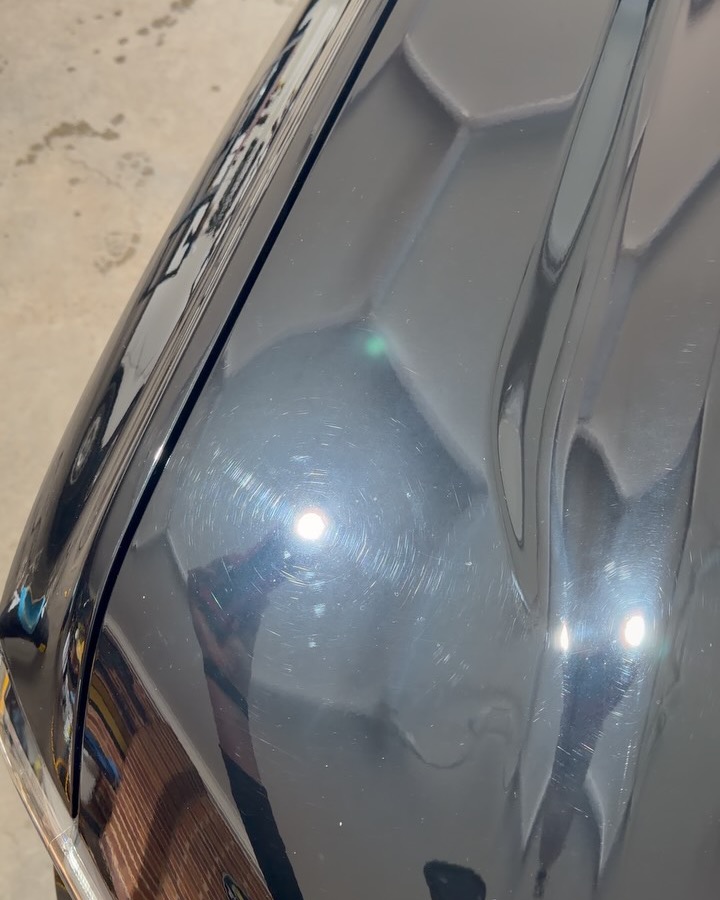 Black Ford Everest bonnet under inspection light, heavy swirl marks then a mirror finish after a three stage paint correction — before